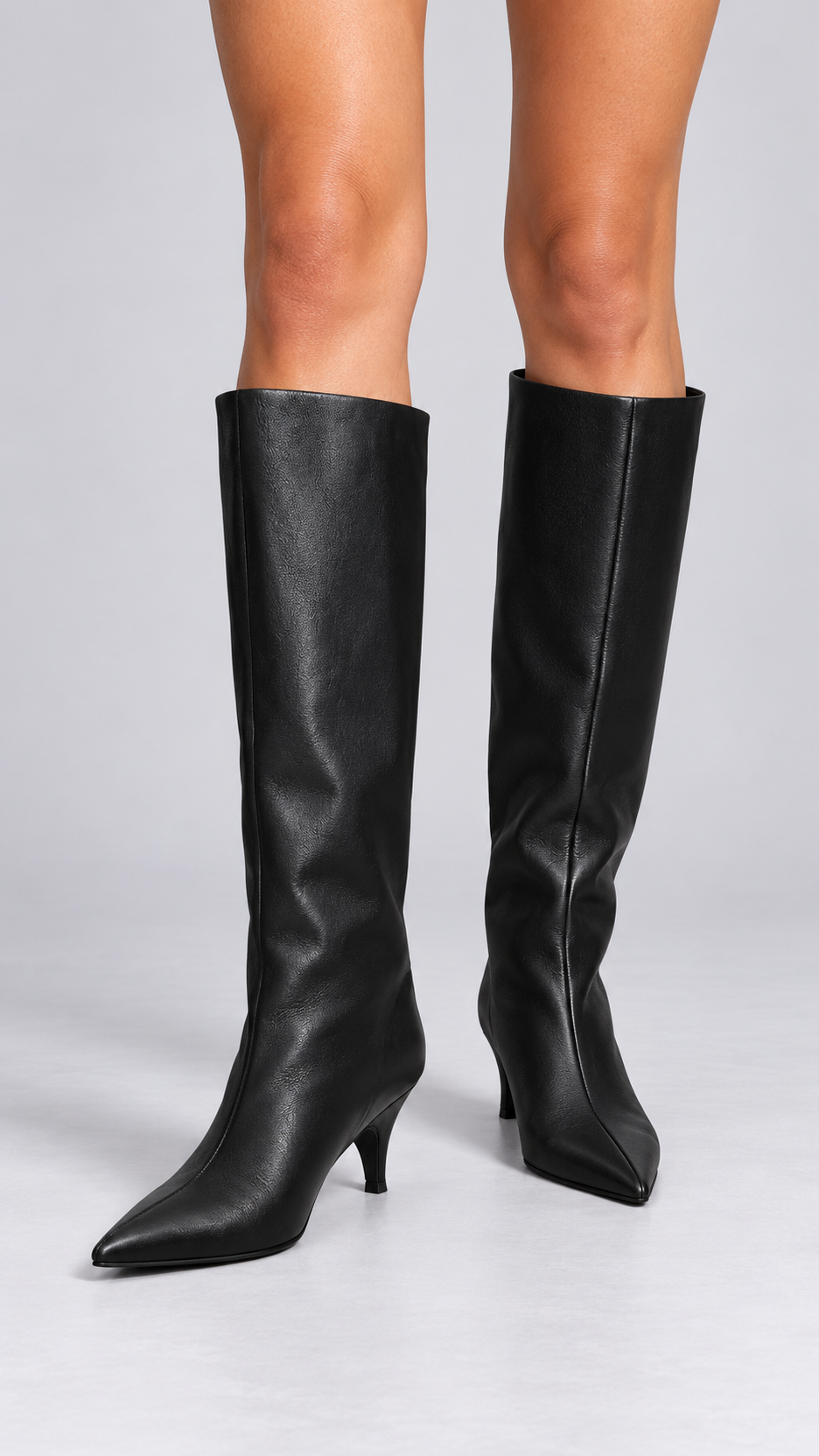 Maribeth Stiletto-Point Knee Boot — Black worn closeup