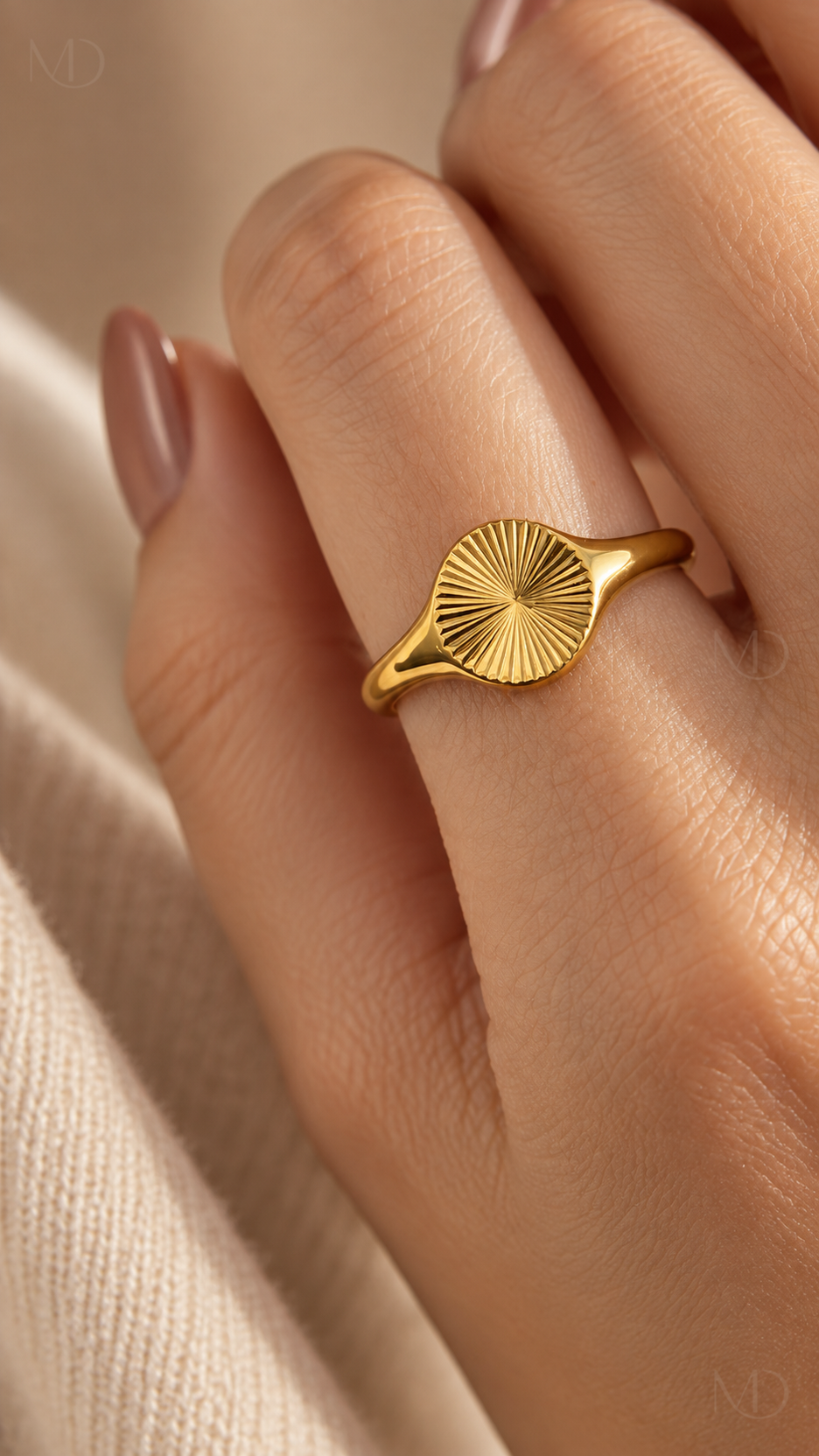 Helia gold sunburst signet ring worn on hand
