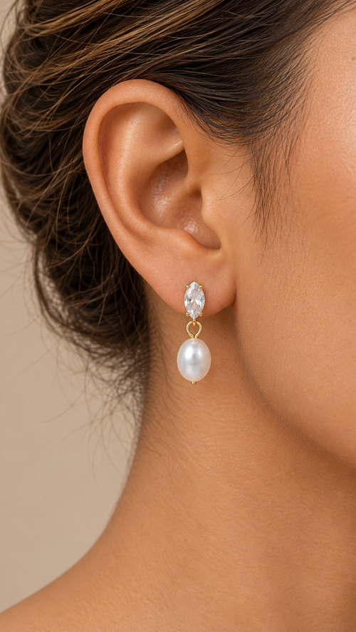 Aveline Teardrop Pearl Earrings — Golden worn closeup