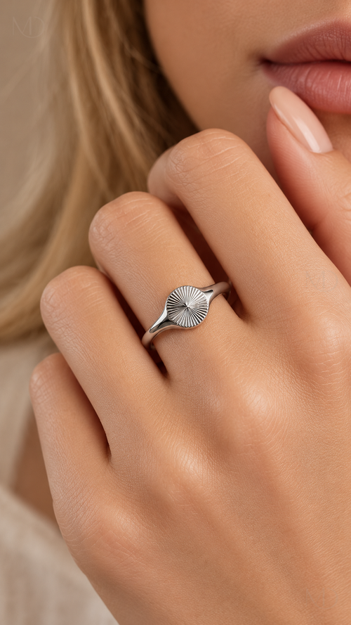 Helia silver sunburst signet ring worn on hand